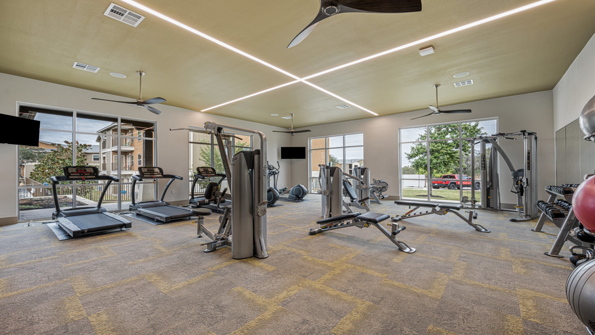 a gym room with exercise equipment and a television at The Panr Hollow