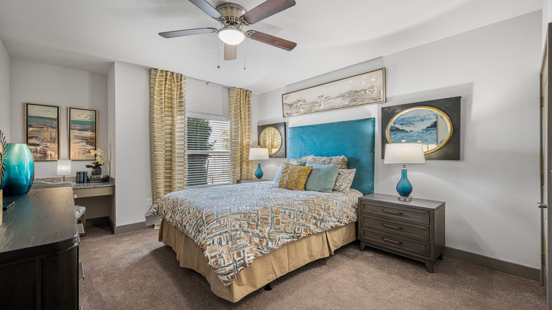 a bedroom with a ceiling fan and blue bed at The Panr Hollow