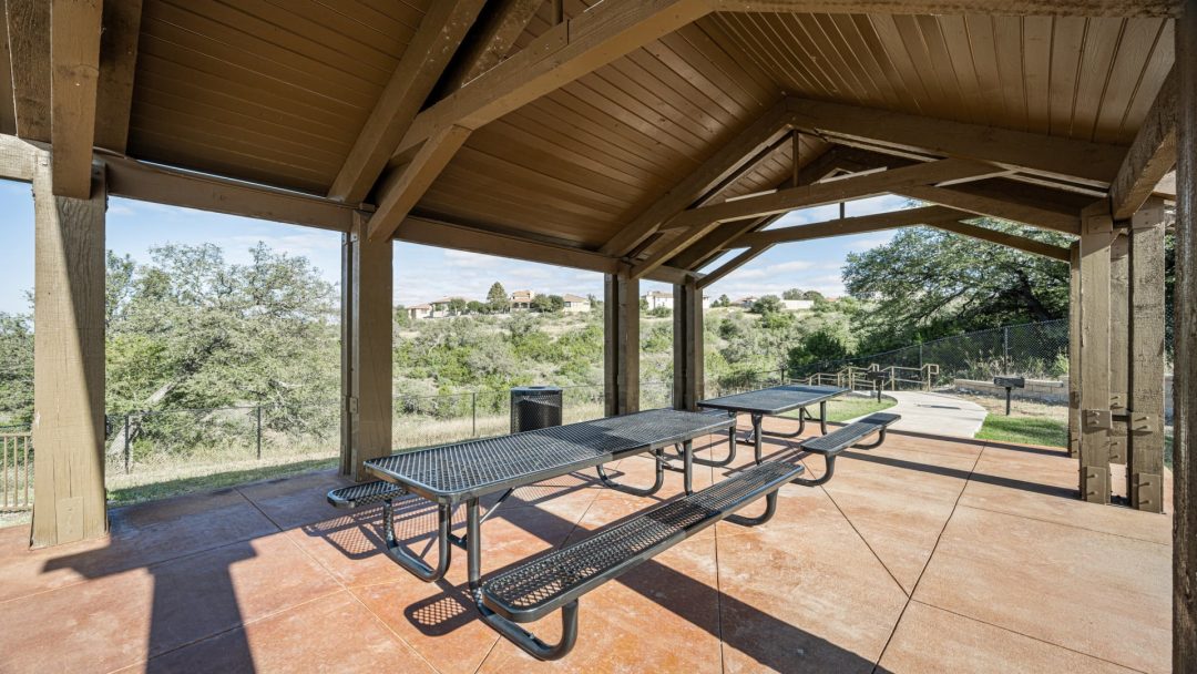 a picnic table under a covered pavilion with a view of the mountains at The Panr Hollow