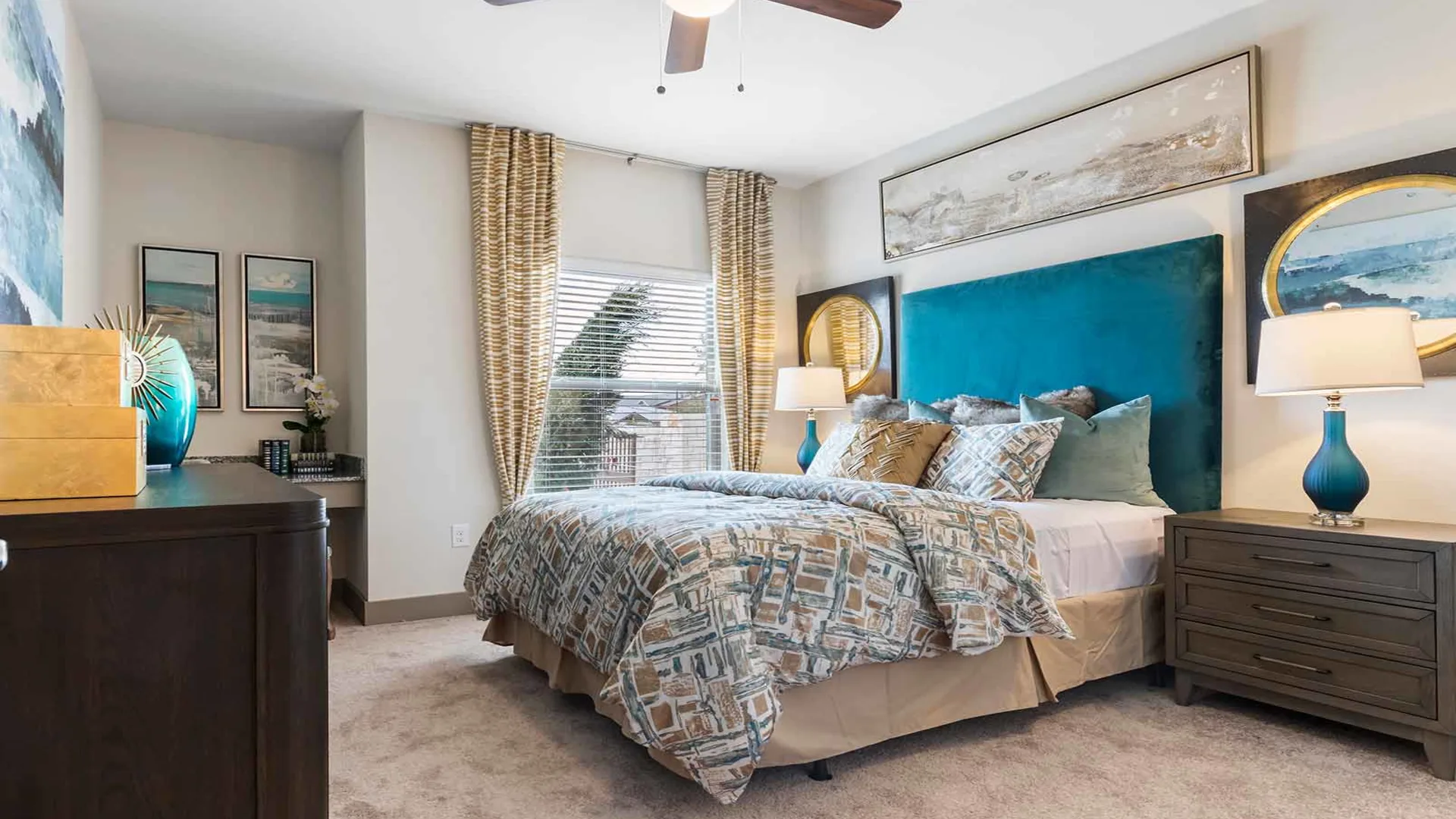 a bedroom with a blue headboard and ceiling fan at The Panr Hollow