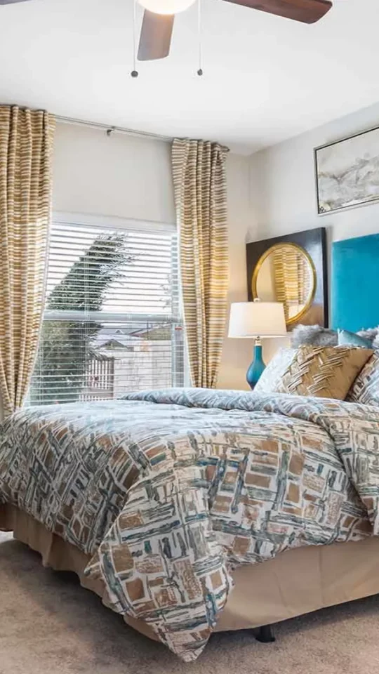 a bedroom with a blue headboard and ceiling fan at The Panr Hollow