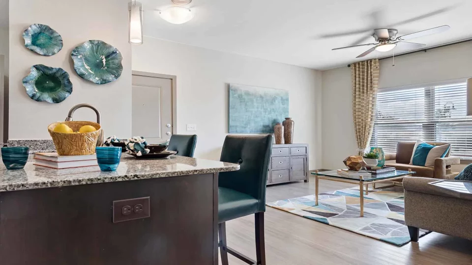 a living room and kitchen area with a blue ceiling fan at The Panr Hollow